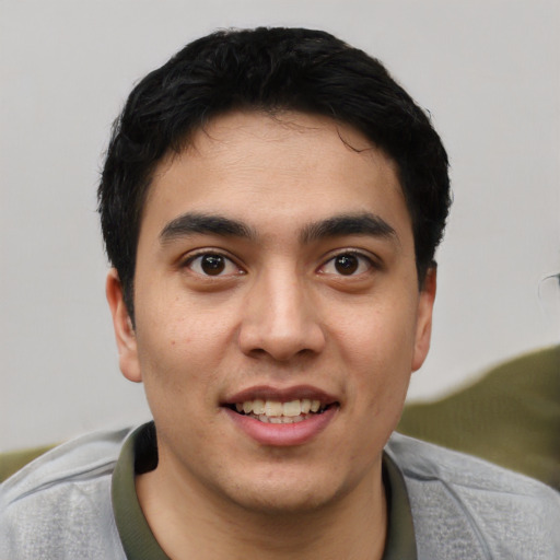 Joyful latino young-adult male with short  black hair and brown eyes