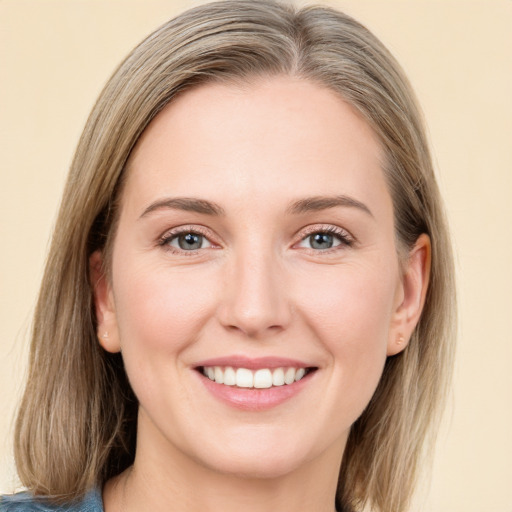 Joyful white young-adult female with medium  brown hair and blue eyes