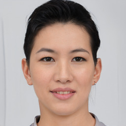 Joyful asian young-adult female with short  black hair and brown eyes