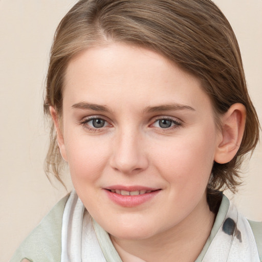 Joyful white young-adult female with medium  brown hair and blue eyes