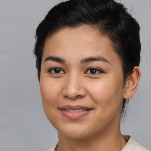 Joyful asian young-adult female with short  brown hair and brown eyes