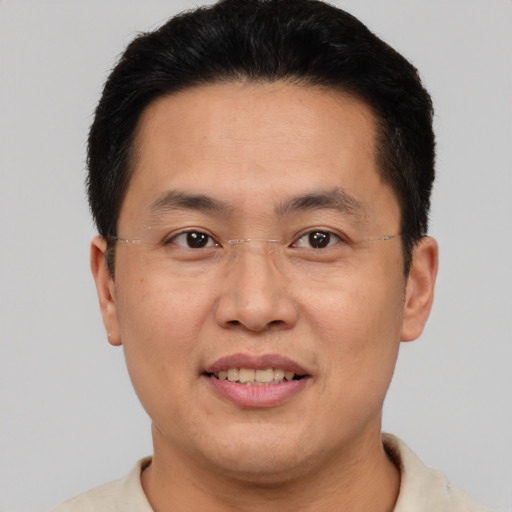 Joyful asian adult male with short  brown hair and brown eyes