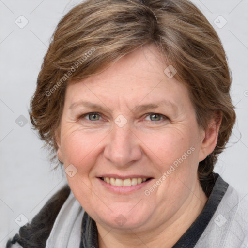 Joyful white adult female with medium  brown hair and blue eyes