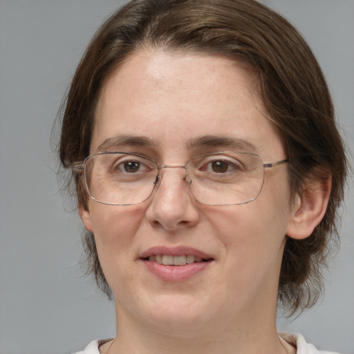 Joyful white adult female with medium  brown hair and brown eyes