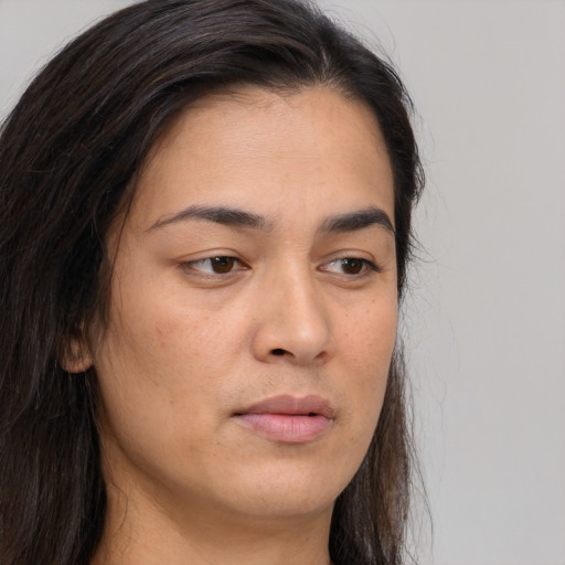 Joyful asian young-adult female with long  brown hair and brown eyes