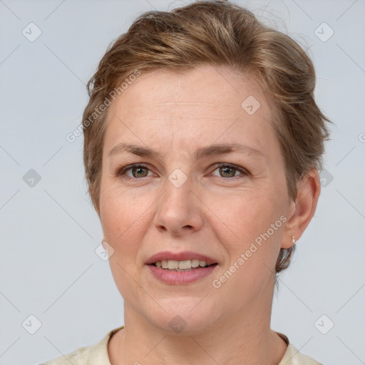 Joyful white adult female with short  brown hair and grey eyes