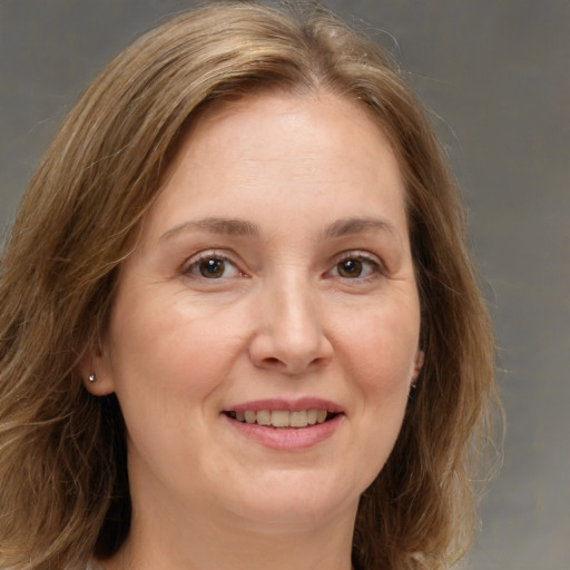 Joyful white adult female with medium  brown hair and brown eyes