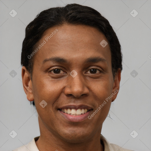 Joyful black adult male with short  black hair and brown eyes