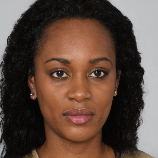 Neutral black young-adult female with long  brown hair and brown eyes