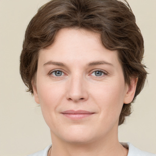 Joyful white young-adult female with medium  brown hair and green eyes