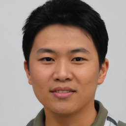 Joyful asian young-adult male with short  black hair and brown eyes