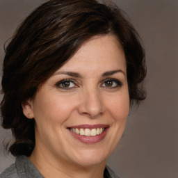 Joyful white adult female with medium  brown hair and brown eyes