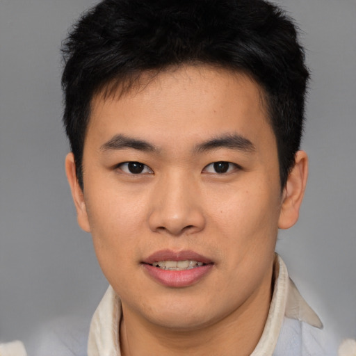 Joyful asian young-adult male with short  brown hair and brown eyes