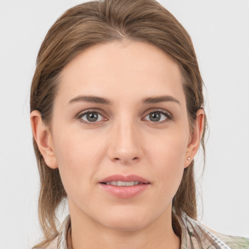 Joyful white young-adult female with medium  brown hair and grey eyes