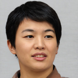 Joyful asian young-adult female with short  black hair and brown eyes