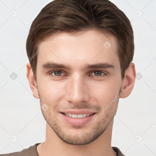 Joyful white young-adult male with short  brown hair and grey eyes