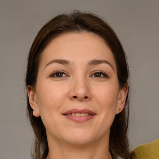 Joyful white young-adult female with medium  brown hair and brown eyes