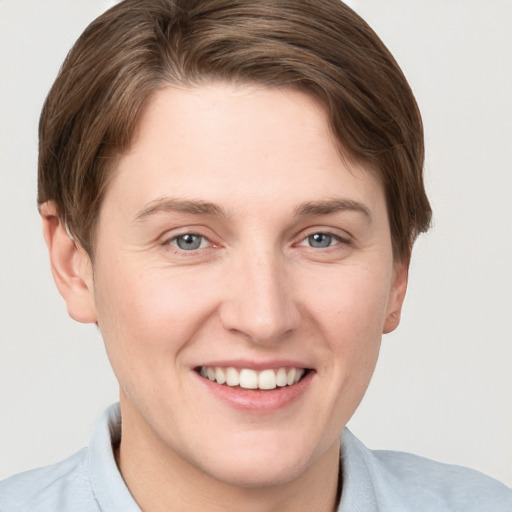 Joyful white young-adult female with short  brown hair and grey eyes