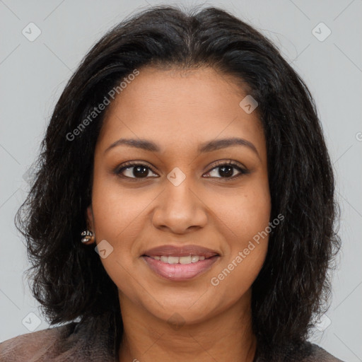 Joyful black young-adult female with long  brown hair and brown eyes