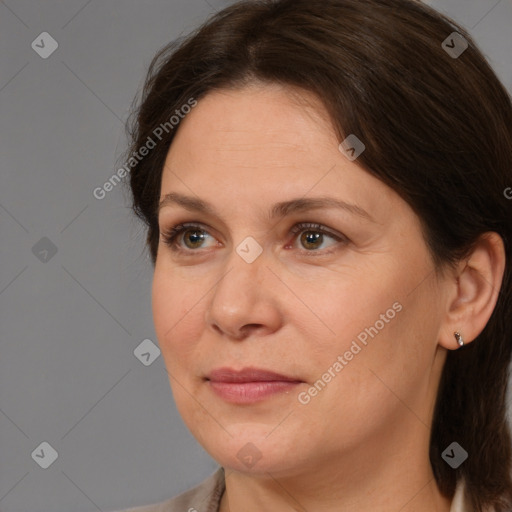 Joyful white adult female with medium  brown hair and brown eyes