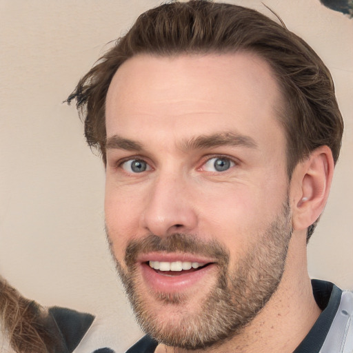 Joyful white young-adult male with short  brown hair and grey eyes