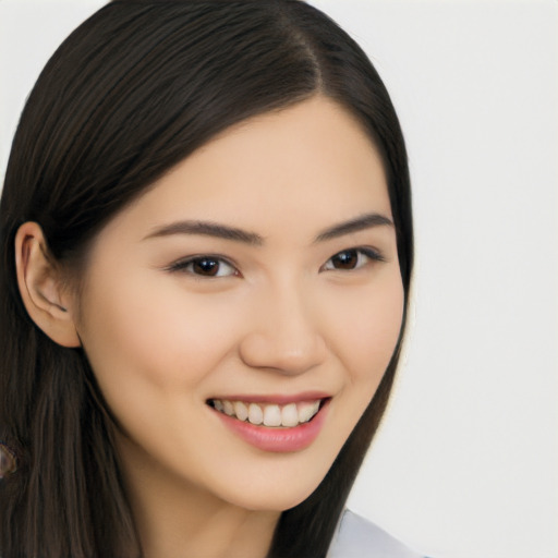 Joyful asian young-adult female with long  brown hair and brown eyes