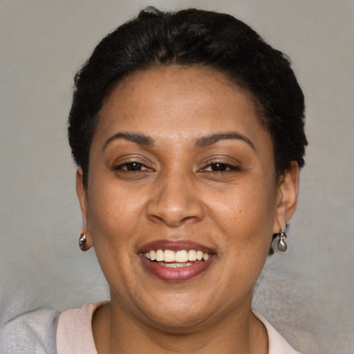 Joyful latino adult female with short  brown hair and brown eyes