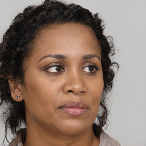 Neutral black young-adult female with medium  brown hair and brown eyes
