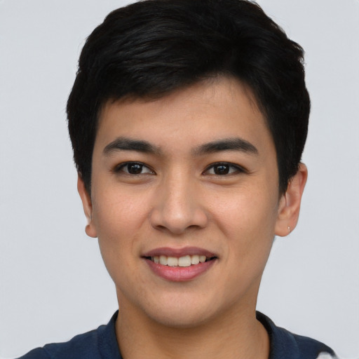 Joyful asian young-adult male with short  black hair and brown eyes