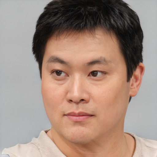 Neutral asian young-adult male with short  brown hair and brown eyes