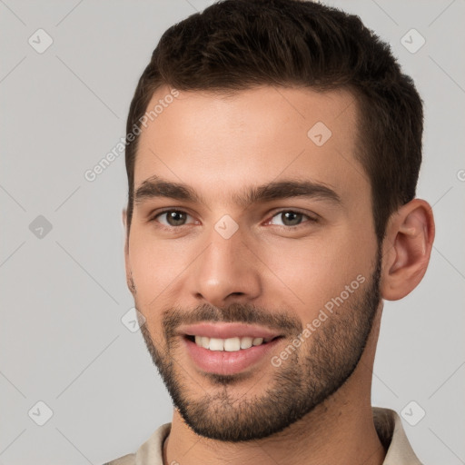 Joyful white young-adult male with short  brown hair and brown eyes