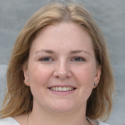 Joyful white young-adult female with medium  brown hair and blue eyes