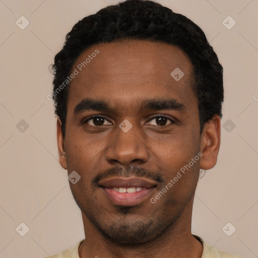 Joyful black young-adult male with short  black hair and brown eyes