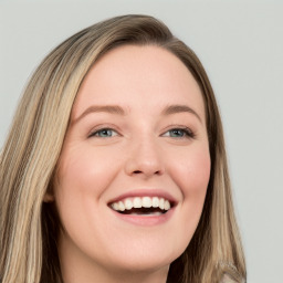 Joyful white young-adult female with long  brown hair and blue eyes