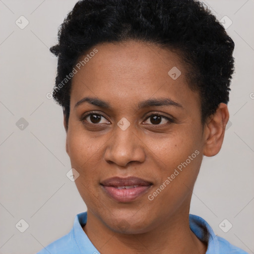 Joyful black young-adult female with short  black hair and brown eyes