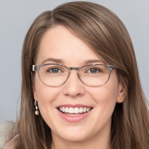 Joyful white young-adult female with long  brown hair and grey eyes