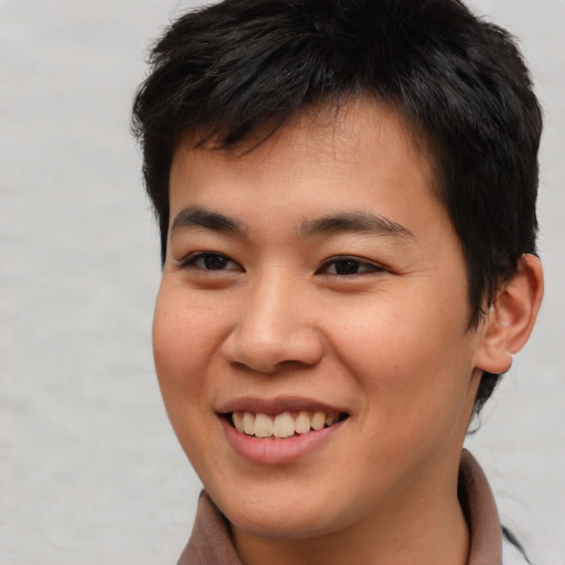 Joyful asian young-adult male with short  brown hair and brown eyes