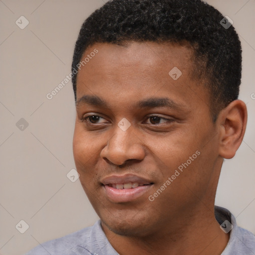 Joyful black young-adult male with short  black hair and brown eyes