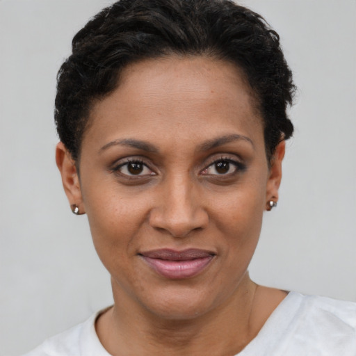 Joyful latino young-adult female with short  brown hair and brown eyes