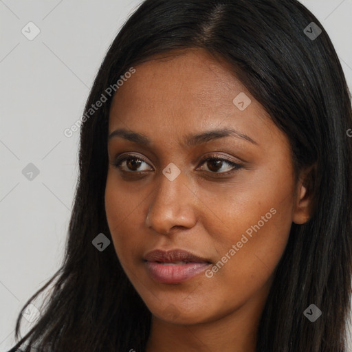 Joyful black young-adult female with long  brown hair and brown eyes