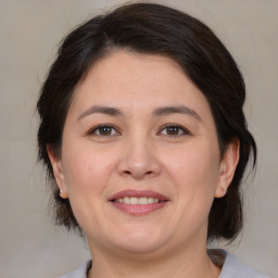 Joyful white adult female with medium  brown hair and brown eyes