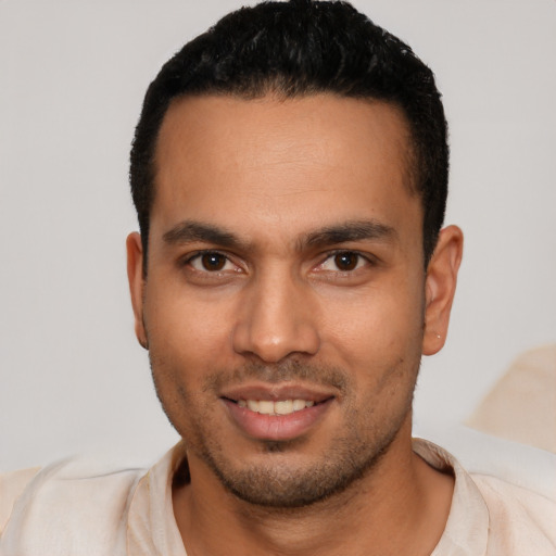 Joyful latino young-adult male with short  brown hair and brown eyes