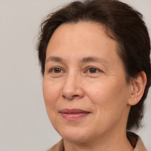 Joyful white adult female with medium  brown hair and brown eyes