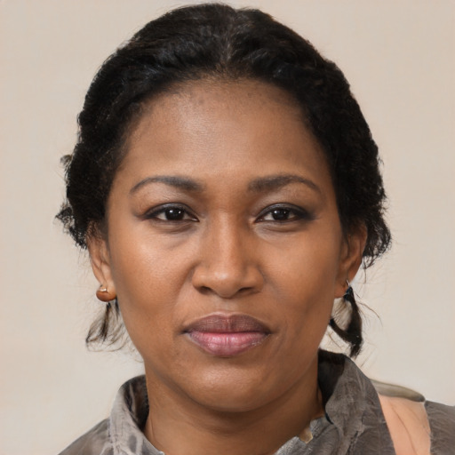 Joyful black adult female with medium  black hair and brown eyes
