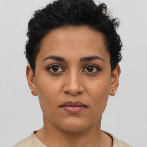 Joyful latino young-adult female with short  brown hair and brown eyes