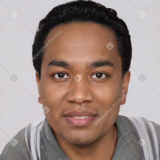 Joyful black young-adult male with short  black hair and brown eyes