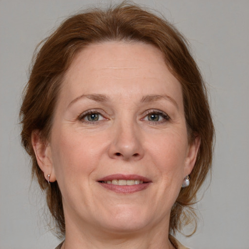 Joyful white adult female with medium  brown hair and grey eyes