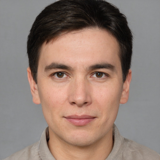 Joyful white young-adult male with short  brown hair and brown eyes