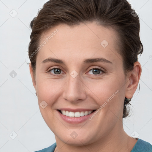 Joyful white young-adult female with short  brown hair and grey eyes