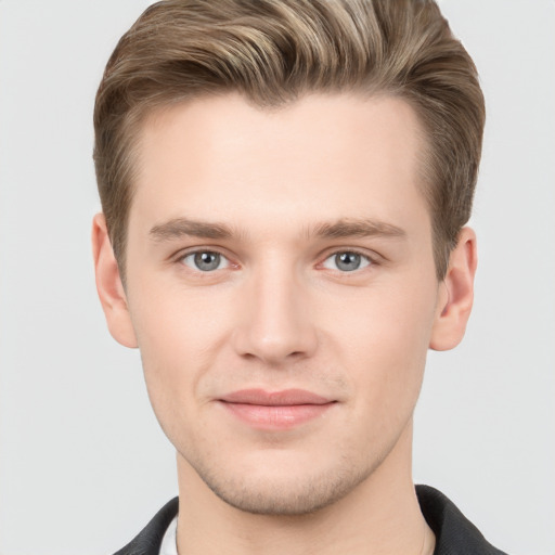 Joyful white young-adult male with short  brown hair and grey eyes